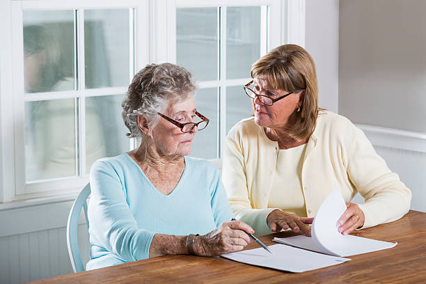 istock Elderly woman reading paperwork 187244389