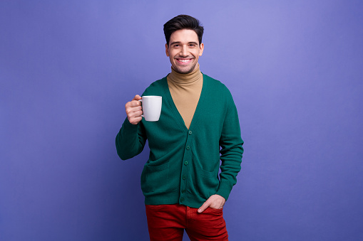 Photo of nice glad confident man chief wear trendy clothes hold cup fresh aromatic caffeine beverage isolated on purple color background.
