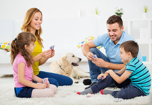 istock Cheerful Family Playing Cards. 187244599