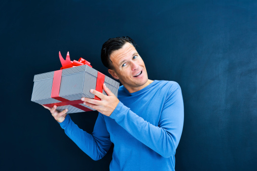 Man guessing what's in the gift box.