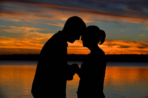 istock Young Couple in Silhouette at Sunset 187247649