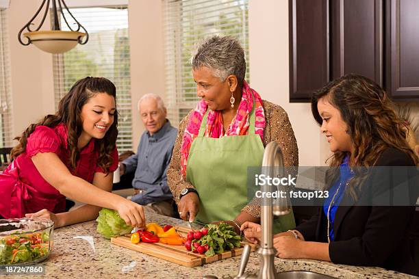 Multiethnic Family And Friends In Kitchen Stock Photo - Download Image Now - Dinner, Neighbor, Teenager