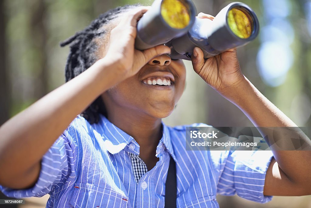 He loves bird watching! Shot of a young boy out in the woods with a pair of binoculars Child Stock Photo