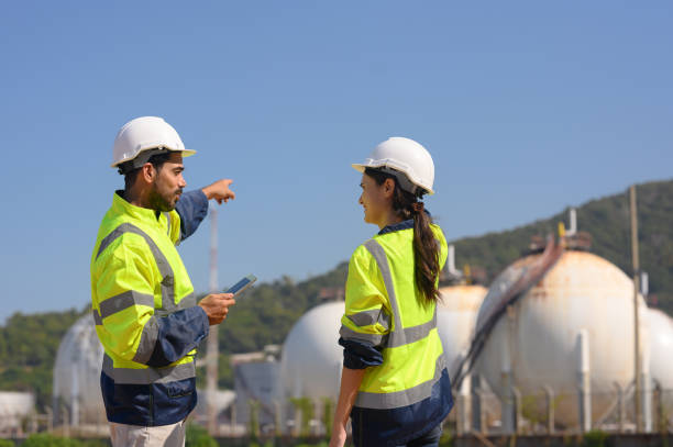 istock Two chemical engineers consult to prepare a work plan for a refinery storage tank. 1872488709