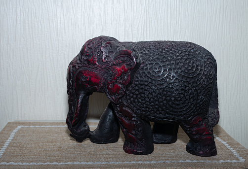 a figurine of a decorative black  carved elephant