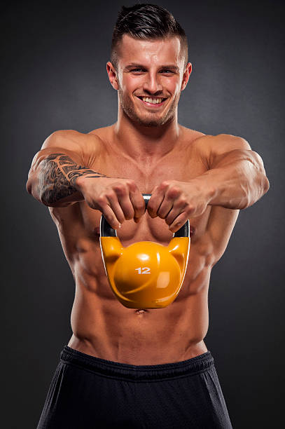 istock Muscular Man Exercise with Kettle Bell 187249147