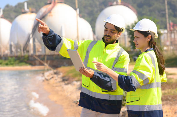 istock Two chemical engineers consult to prepare a work plan for a refinery storage tank. 1872492780