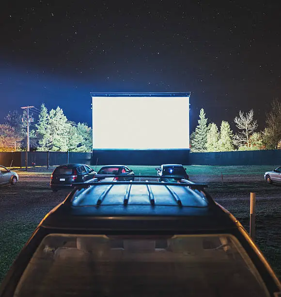 Drive in movie goers enjoy a screening under clear Autumn skies.  Long exposure.