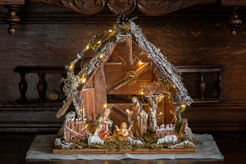 Beautiful Christmas nativity scene with holy family in a handmade wooden old stable, Italian traditional Presepio or Presepe made by me (Michele Ursi) in Vilnius, Lithuania on 1st of December 2022