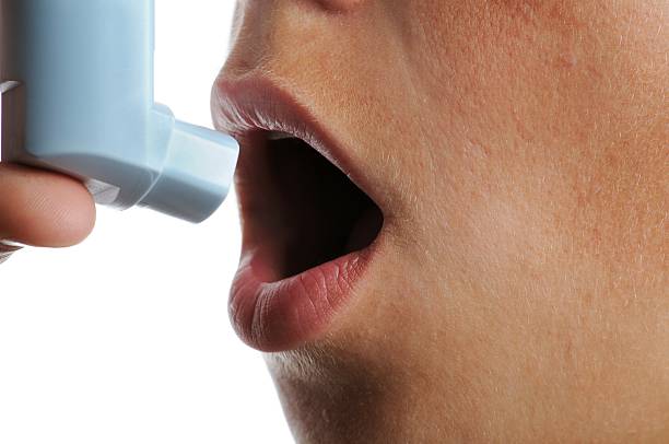istock Young person about to use asthma inhaler 187250843