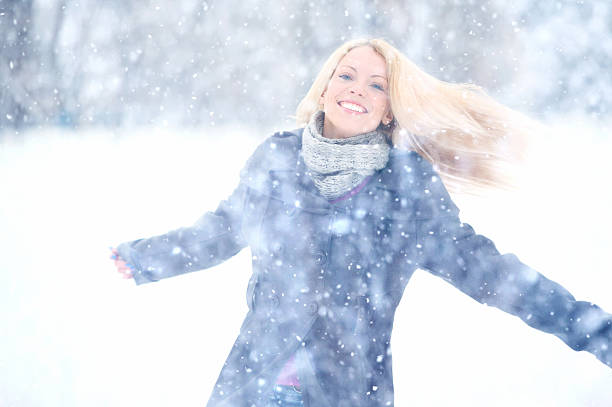 istock Woman having fun on a snowy day. 187251059