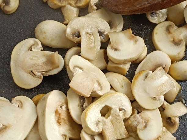 istock button mushrooms cooking in a pan 1872511626