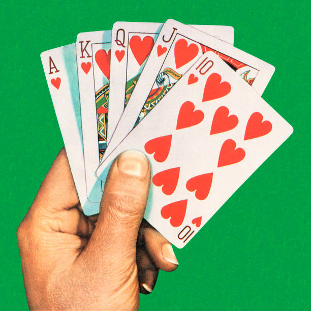 A hand holding a royal flush cards Royal Flush Hand of Cards hearts playing card illustrations stock illustrations