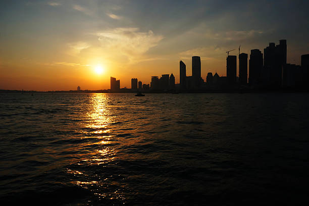 istock city sea boat sunset 187253668