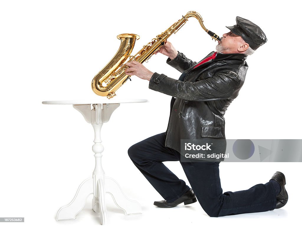 man playing the trumpet man in a jacket and hat playing a trumpet on a white background Adult Stock Photo
