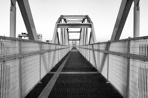 Symmetrical metal bridge, vanishing point perspective, monochrome