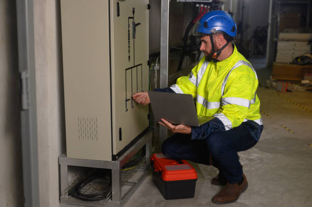 istock engineering technician Setting up the solar panel inverter in the electrical room Service engineer installs solar cells on factory roofs Concept of clean energy and renewable energy 1872549125