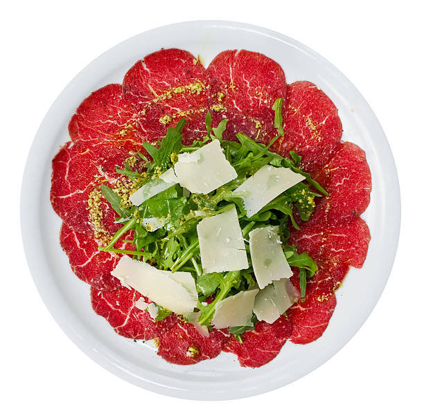 Carpaccio Overhead Carpaccio is a dish of raw meat  (such as beef, veal or venison), thinly sliced or pounded thin and served mainly as an appetizer. carpaccio parmesan cheese beef raw stock pictures, royalty-free photos & images