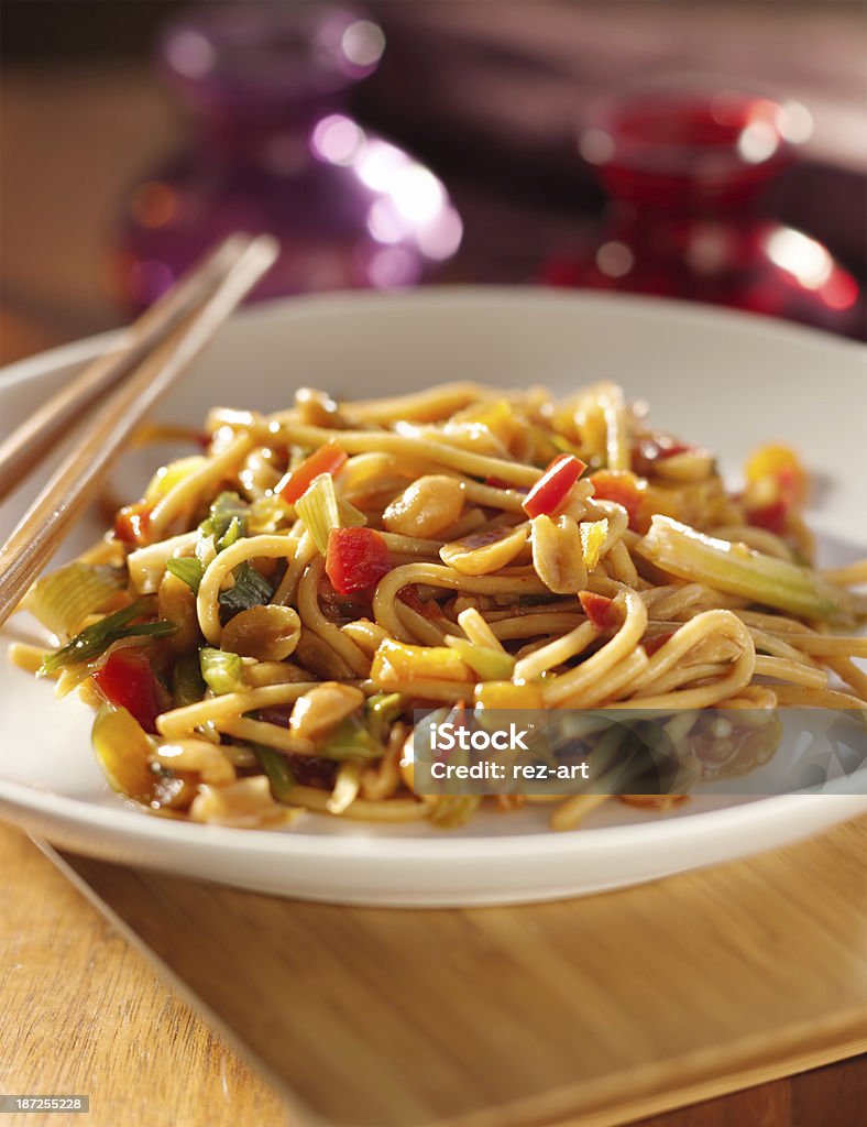 spicy thai noodles with chopsticks. close up photo of  a plate ofspicy thai noodles with chopsticks. Asia Stock Photo