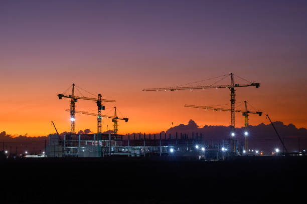 istock Silhouette of a building with backlit orange sky during sunset. 1872552967