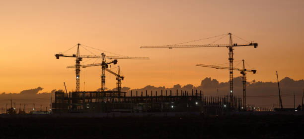 istock Silhouette of a building with backlit orange sky during sunset. 1872558889