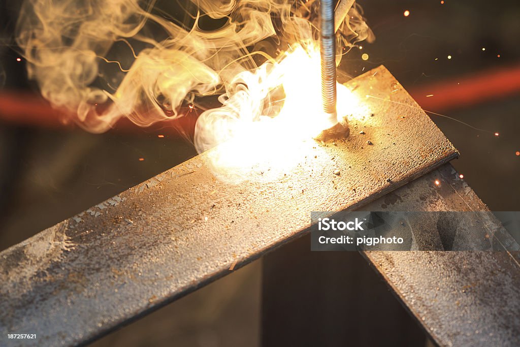 worker with welding metal worker with welding metal and sparks  welding with sparks Adult Stock Photo