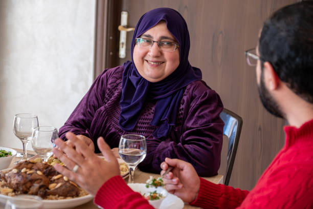 istock young bearded man talking to his mother on during lunch 1872581526