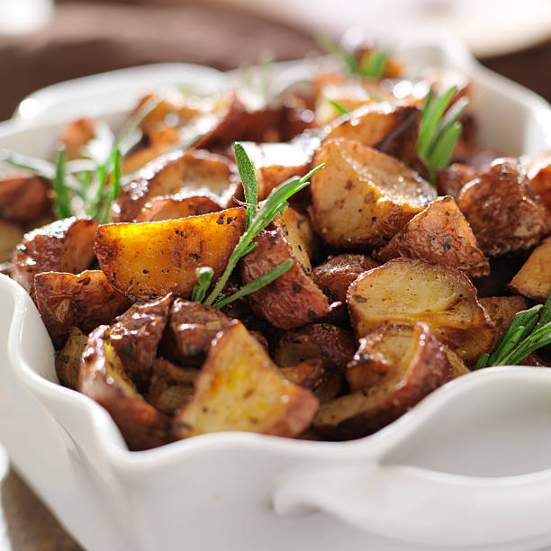 istock rosemary herb potatoes in white baking dish. 187258205