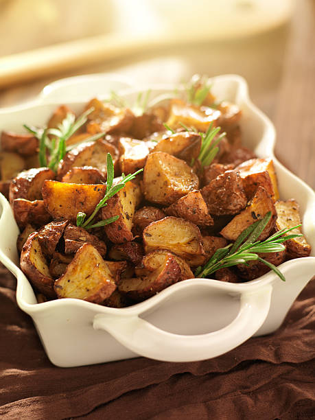 istock rosemary herb potatoes in white baking dish. 187258515