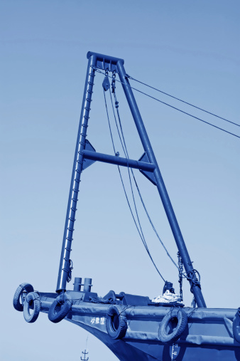 lifting equipment on the ship under the blue sky