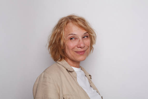 istock Cheerful smiling woman looking back on white color background 1872586733