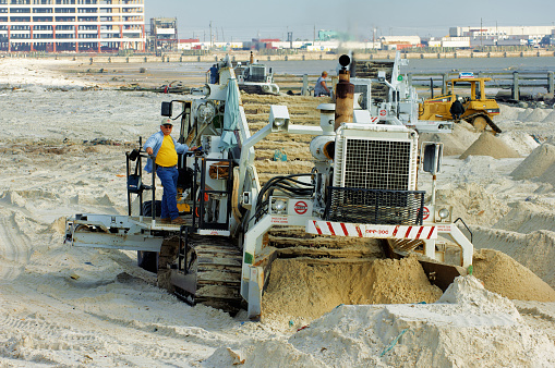 Machines cleaning beach of debris after Hurricane Katrina, Gulfport, Mississippi 2005