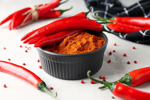 Red Chili Pepper whole and sliced on slate platter