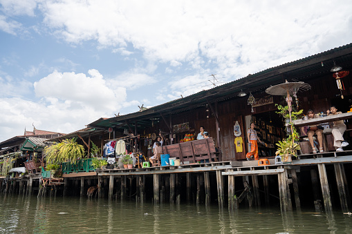 old wooden houses with balconies, which are used as bars or restaurants, at the front of a klong of the Chao Phraya River in Bangkok Thailand Asia
In this picture from the western part of Bangkok, the district of Thonburi, you can see the buildings with their people.
Bangkok Thailand Asia
12/18/2023