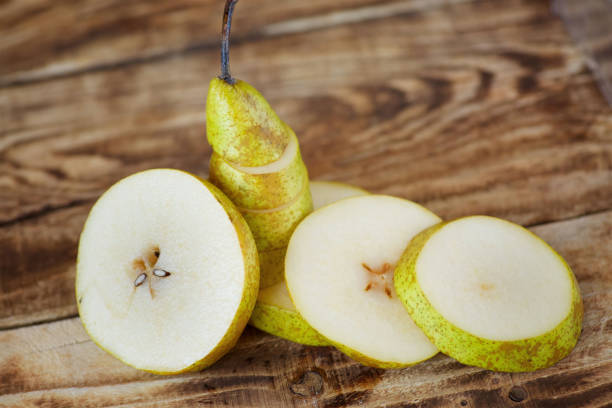 istock Fruit yellow ripe pear, cut into pieces. Vegetarian diet. 1872637659
