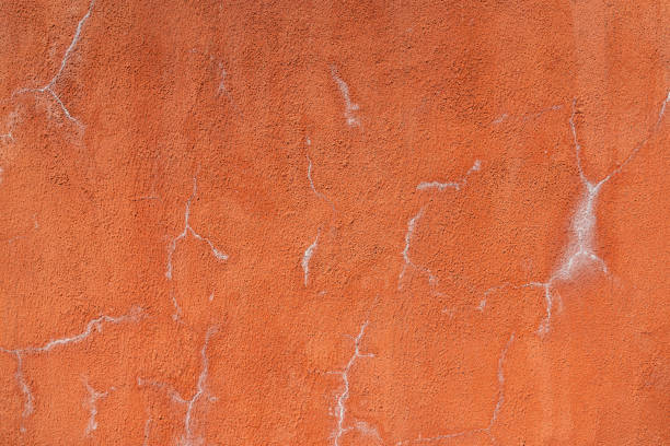 istock Roughly concrete wall with cracked line. 1872639374
