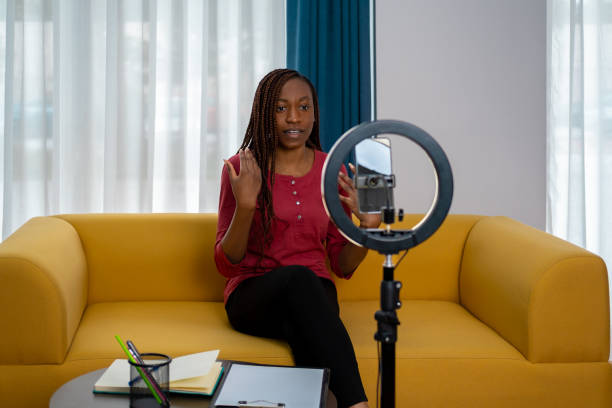 istock African woman vlogging at home 1872641196