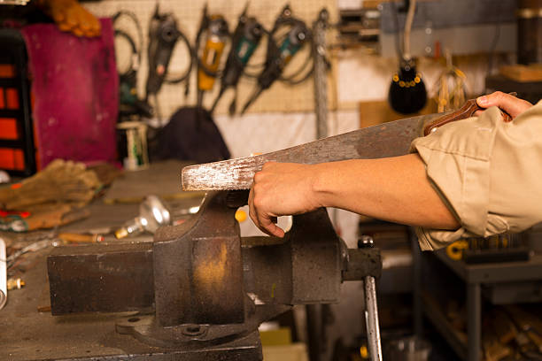 istock Construction: Man uses saw to cut wood in workshop. 187264225
