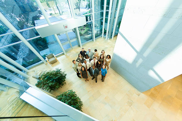 istock Business: Group of multi-ethnic co-workers gather in office lobby. 187264513