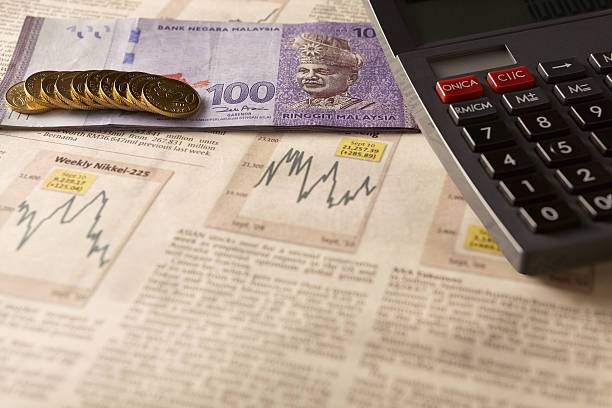 Newspaper stock market with calculator and money stock photo