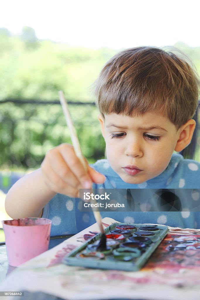 Little child paints Little child paint with paintbrush outdoor Activity Stock Photo
