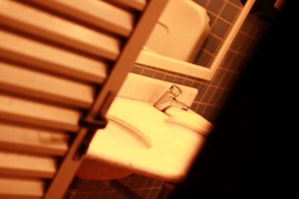 warm light cozy Interior of bathroom with mirror reflection and sink basin