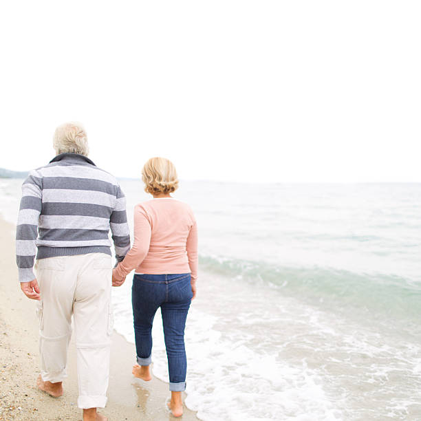 istock Loving senior couple walking on the beach 187267094
