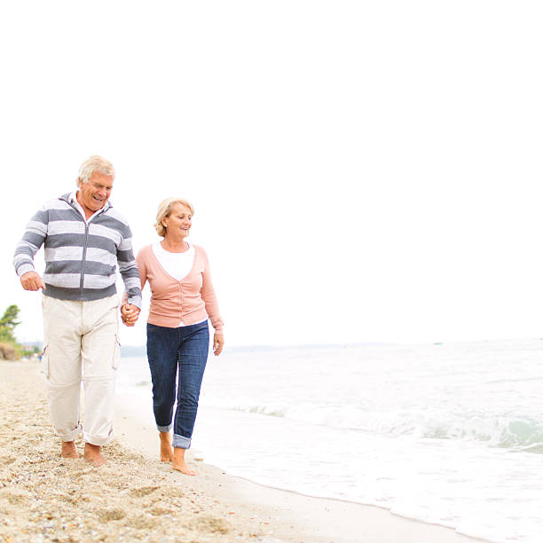 istock Loving senior couple walking on the beach 187267118