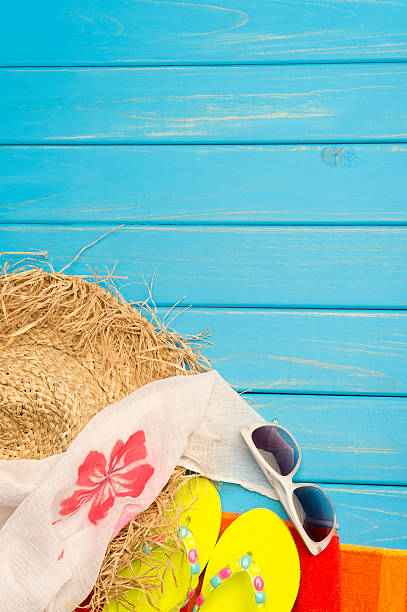 istock Beach scene with hat, thongs and blue wood decking 187267292