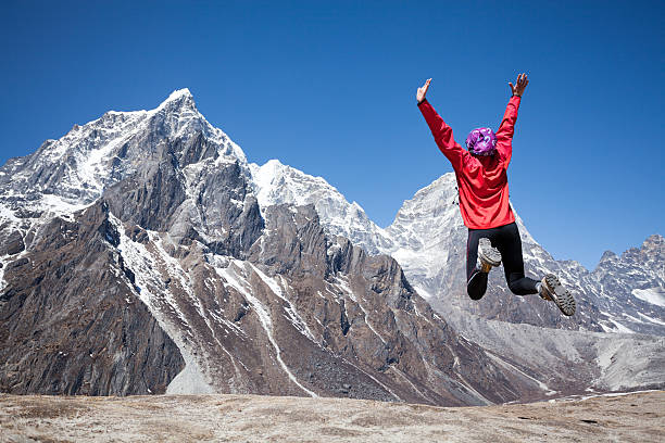 istock Happy woman celebrates successful climb on Himalayas 187268314