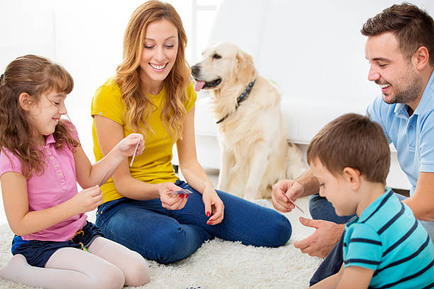istock Cheerful Family Playing Cards. 187268912