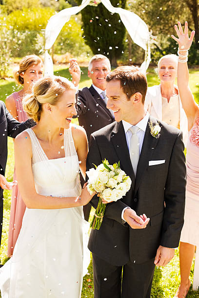 istock Guests Throwing Confetti On Bride And Groom During Ceremony 187270464