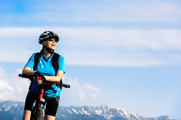 istock cheerful woman on bike 187271020
