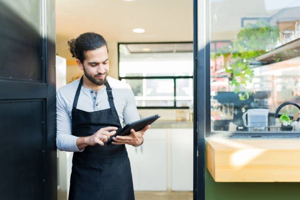 istock Hispanic man and entrepreneur opening her restaurant cafe 1872712903